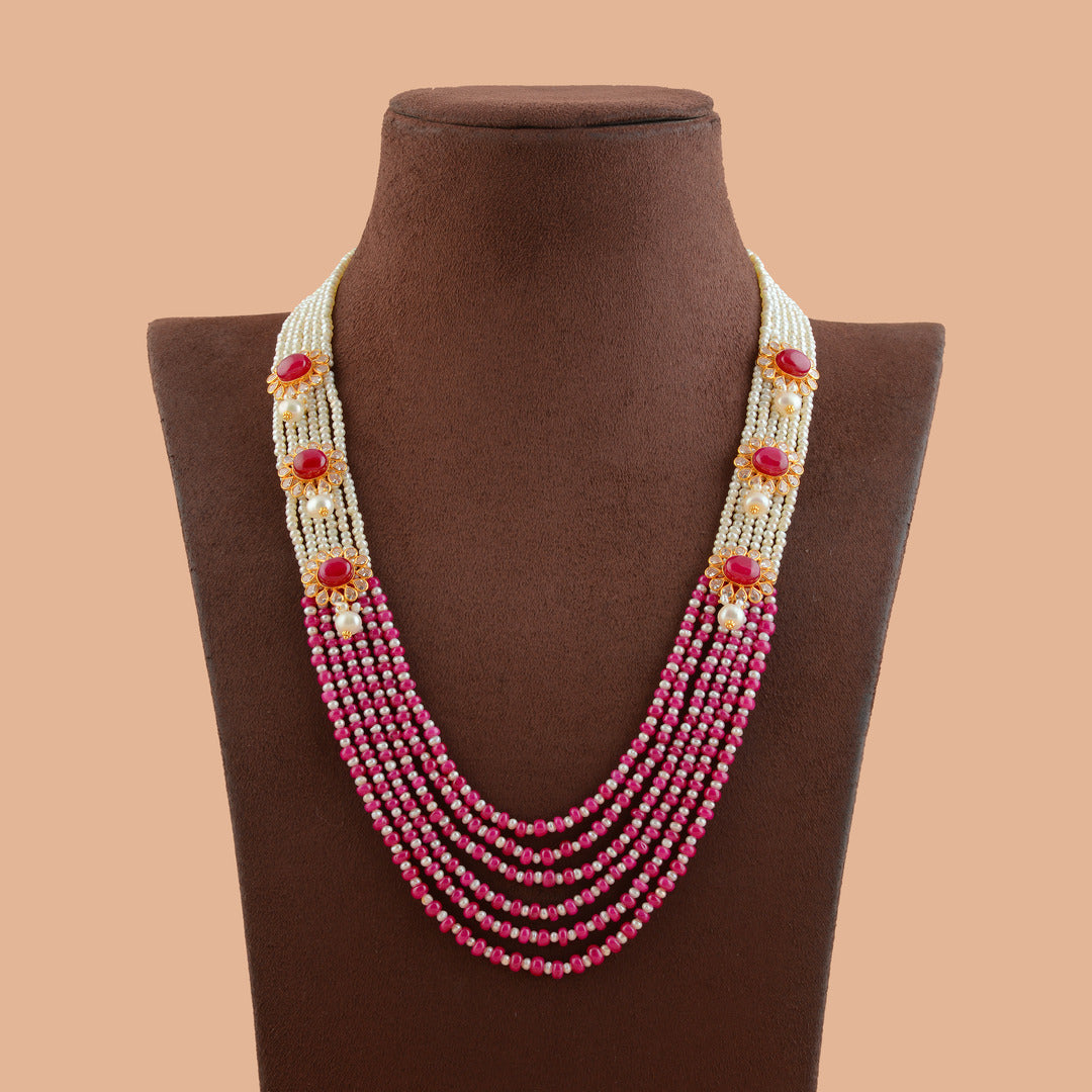 Men's four-strand pearl haram with a polki pendant centred on a pear-cut ruby, shown on a display bust