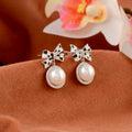 Pearl earrings with bow shape