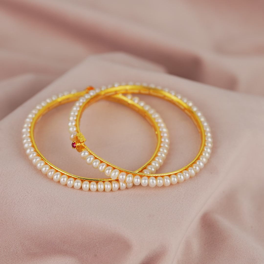 Elegant White Pearl Bangles with Sparkling Red Stones