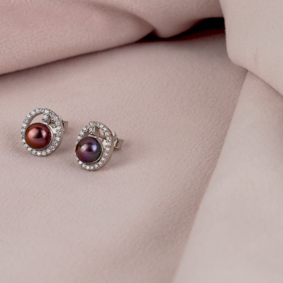 Captivating stud earrings set with a fresh water pearl and CZ stones