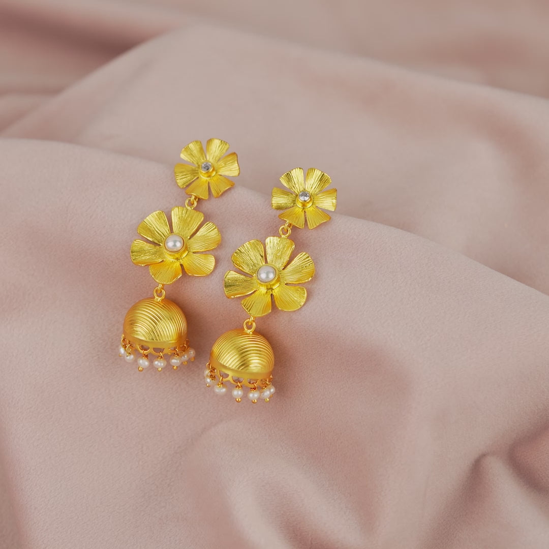 Button pearls adorn silver Jhumka earrings