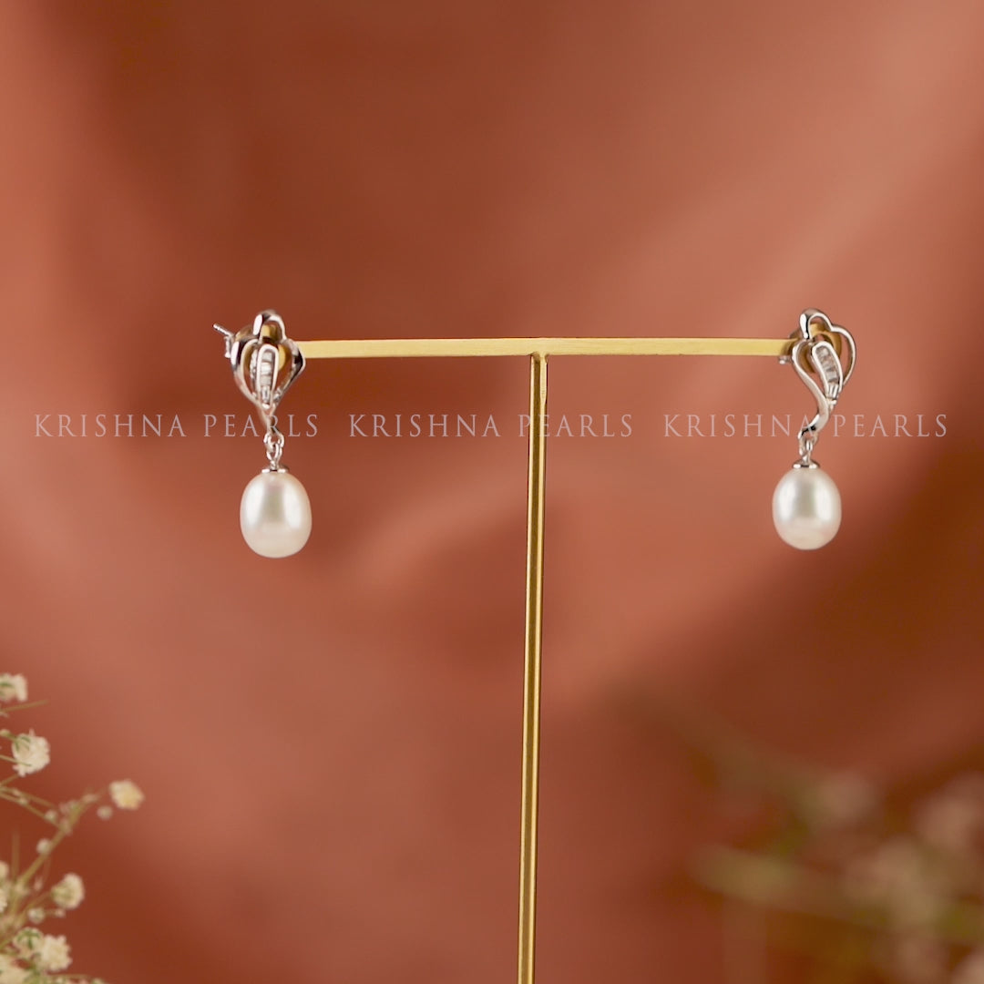Silver paan leaf earrings with pearls.
